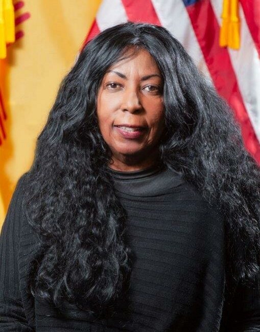 Headshot of woman with long dark hair facing camera