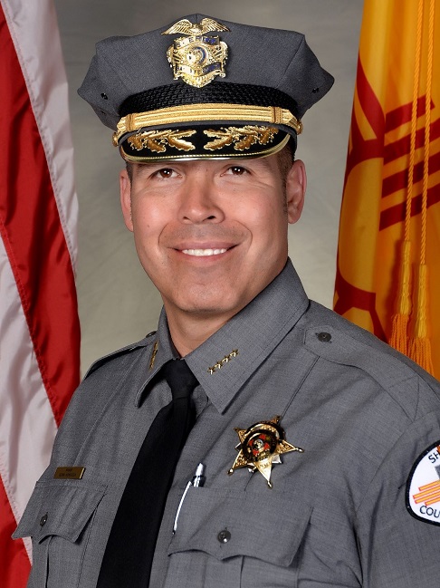 Head shot of man in uniform smiling widely